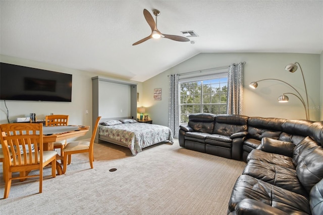 carpeted bedroom featuring vaulted ceiling, visible vents, and ceiling fan