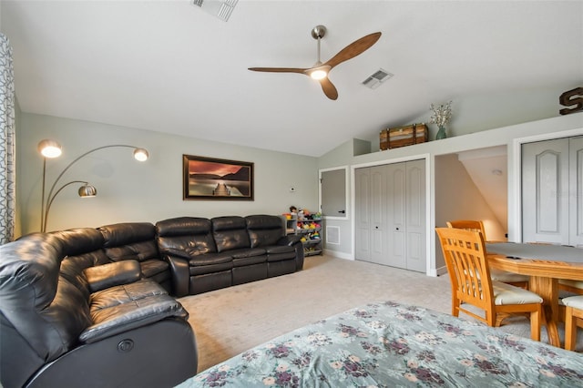 living area with vaulted ceiling, carpet flooring, visible vents, and ceiling fan