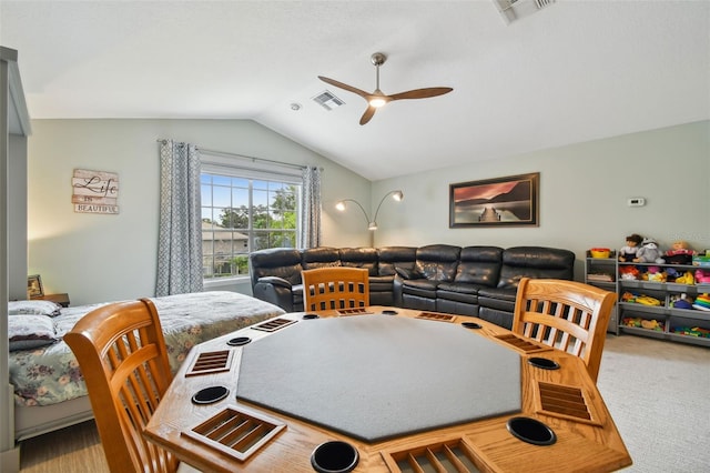 dining area featuring visible vents, carpet floors, a ceiling fan, and vaulted ceiling