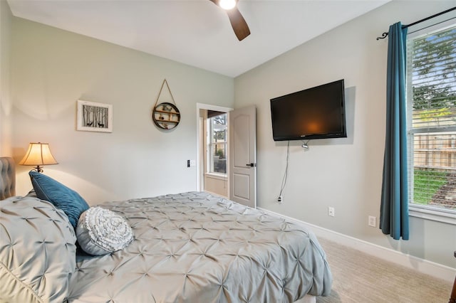 carpeted bedroom featuring a ceiling fan and baseboards