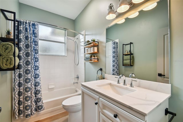 bathroom with vanity, shower / bath combination with curtain, and toilet