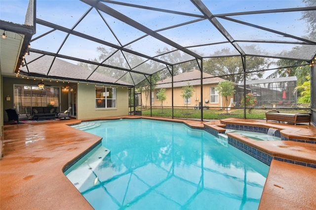 view of pool featuring a patio, a pool with connected hot tub, and a lanai