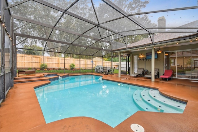 view of swimming pool featuring a patio, a fenced backyard, glass enclosure, a fenced in pool, and an in ground hot tub