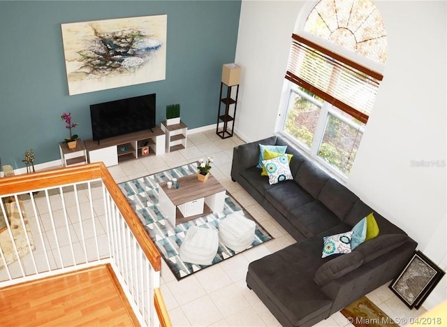 living room with tile patterned flooring and baseboards