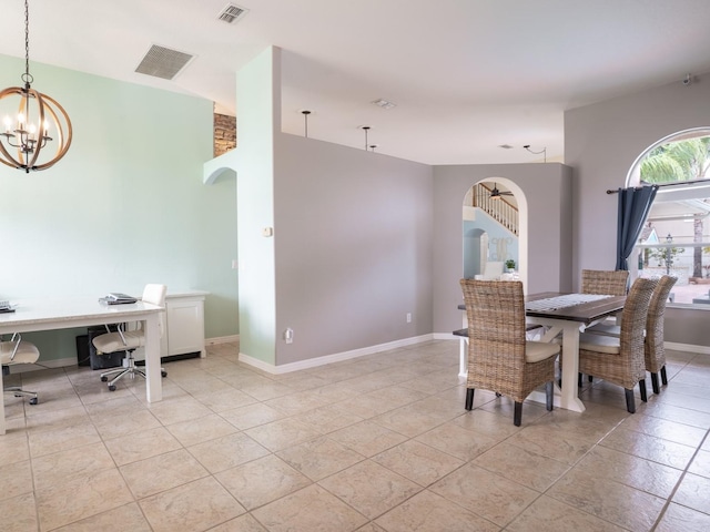 dining area with visible vents, arched walkways, baseboards, and a chandelier