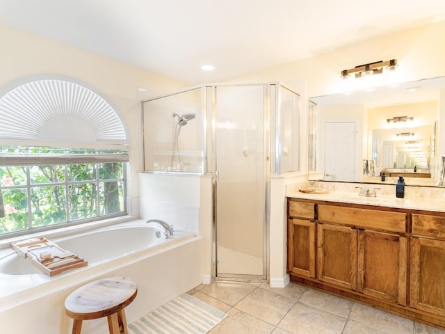 bathroom with a bath, tile patterned flooring, a stall shower, and vanity