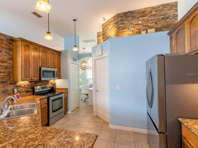 kitchen with backsplash, decorative light fixtures, appliances with stainless steel finishes, light tile patterned flooring, and a sink