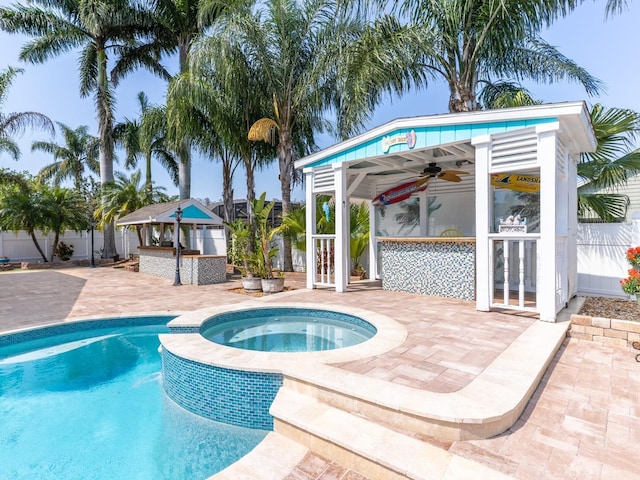 view of swimming pool with outdoor dry bar, fence, a gazebo, french doors, and a patio