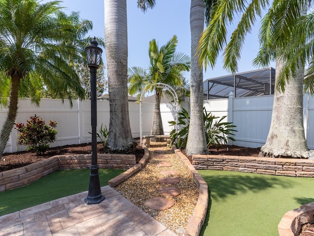 view of yard featuring a lanai and a fenced backyard