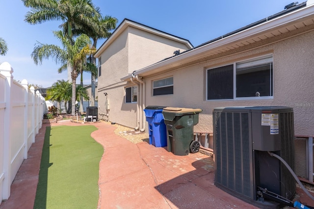 view of home's exterior featuring cooling unit, a patio, a fenced backyard, and stucco siding