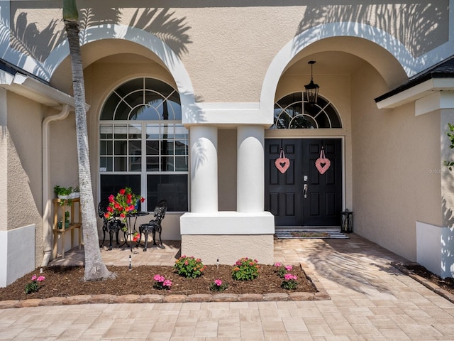 doorway to property with stucco siding