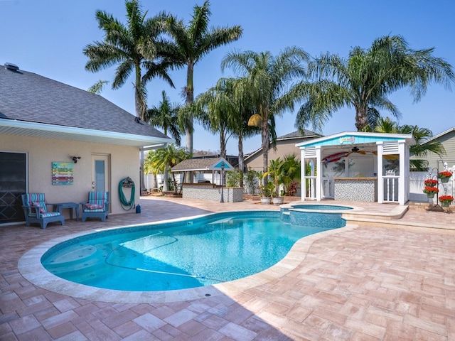 view of swimming pool with a gazebo, a patio, an outdoor structure, and a pool with connected hot tub