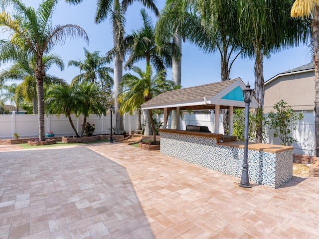 view of patio / terrace featuring a gazebo, area for grilling, and a fenced backyard