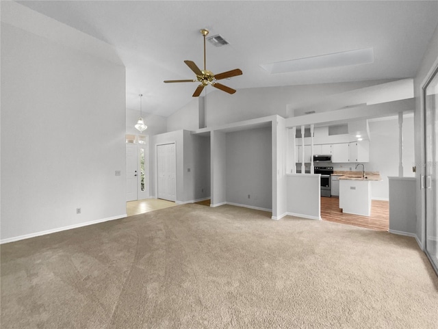 unfurnished living room with visible vents, light colored carpet, high vaulted ceiling, and ceiling fan