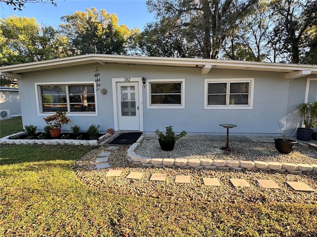 view of front of property featuring a front yard and stucco siding