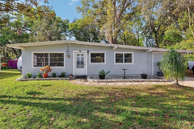 view of front of home with stucco siding and a front yard