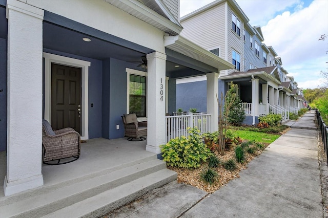 view of home's exterior featuring stucco siding, covered porch, and a ceiling fan