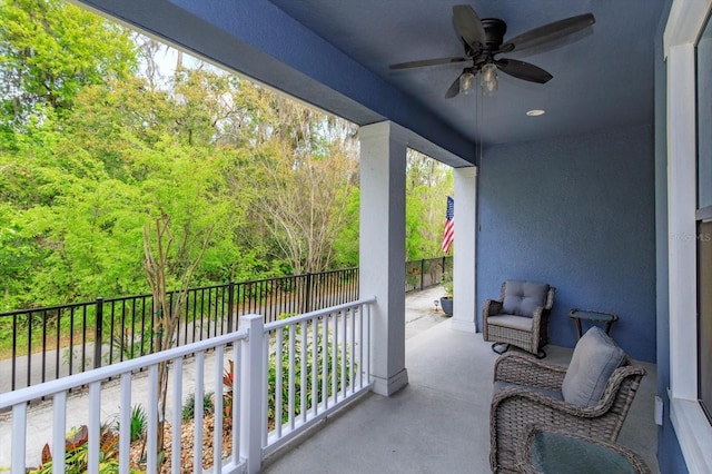 view of patio featuring a balcony and ceiling fan