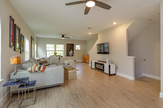 living room with visible vents, recessed lighting, light wood-type flooring, and baseboards