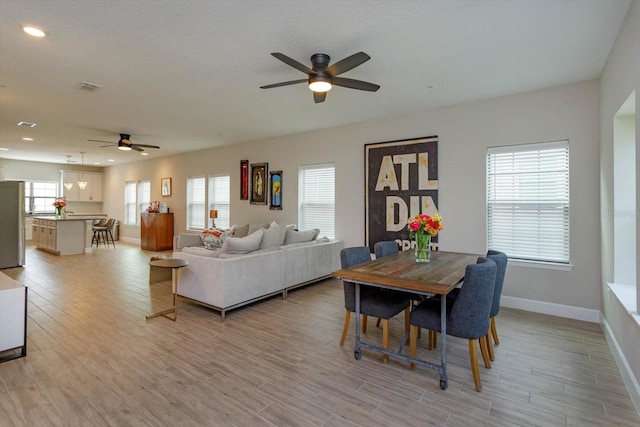 interior space featuring light wood finished floors, visible vents, baseboards, ceiling fan, and recessed lighting