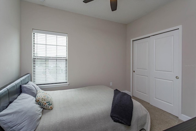 bedroom with a closet, baseboards, ceiling fan, and carpet floors