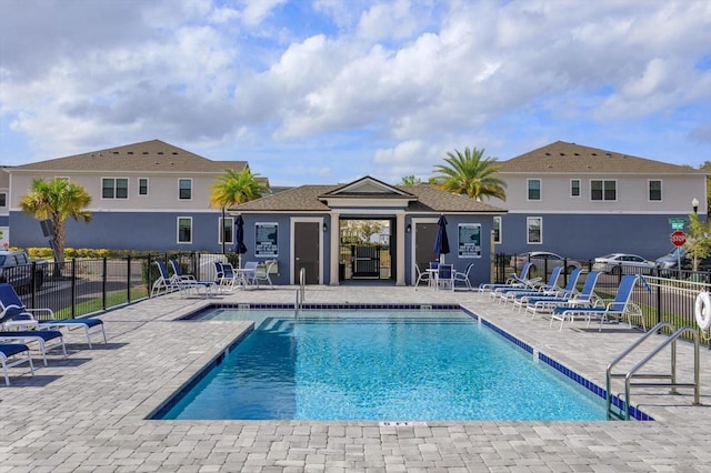 community pool featuring a patio and fence