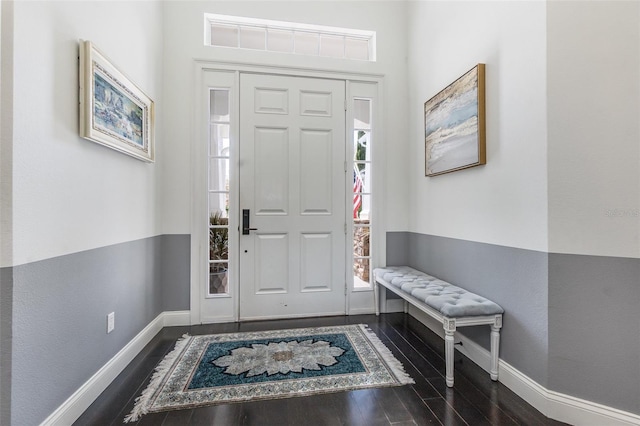 foyer entrance with baseboards and dark wood-style floors