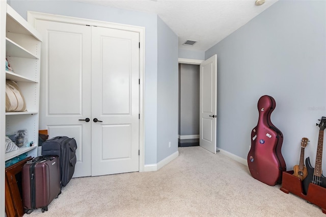 interior space with visible vents, carpet floors, and baseboards