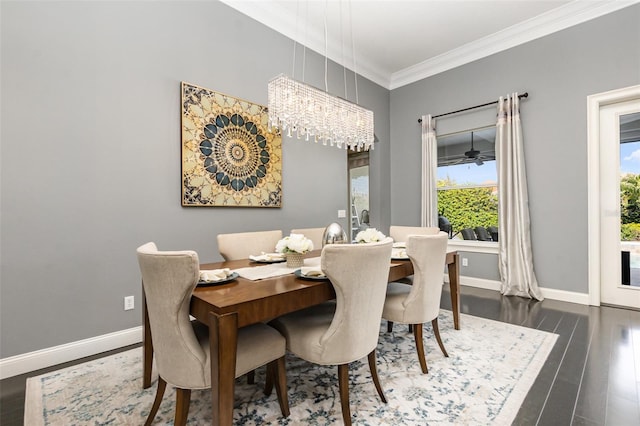 dining room with a chandelier, baseboards, wood finished floors, and crown molding