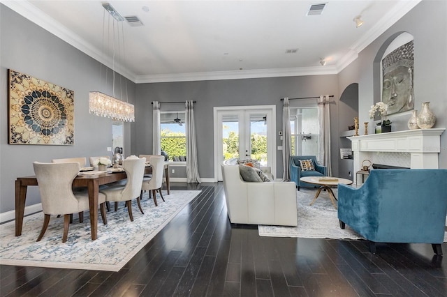 living area with visible vents, wood finished floors, a fireplace, and french doors