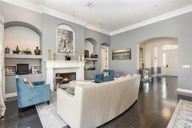 living room featuring visible vents, a warm lit fireplace, crown molding, and wood tiled floor