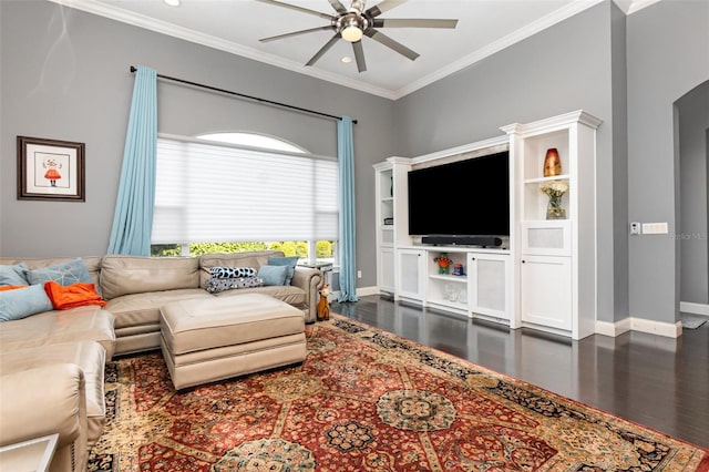 living area with a ceiling fan, dark wood-style floors, baseboards, and ornamental molding