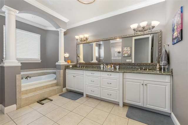 bathroom with a garden tub, ornamental molding, a sink, tile patterned flooring, and decorative columns