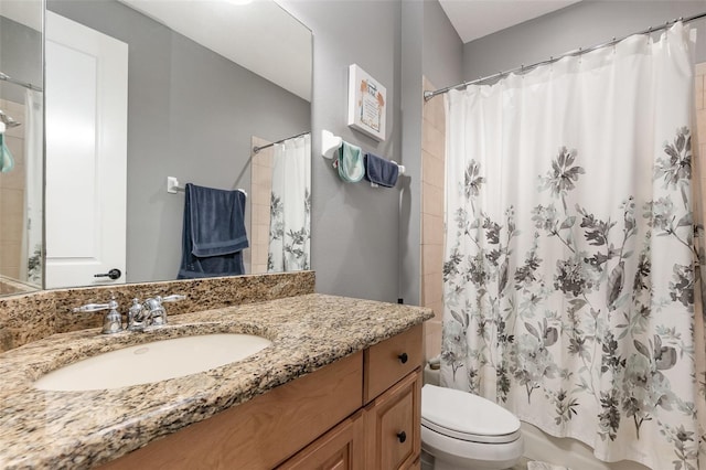 full bath featuring vanity, toilet, and shower / tub combo