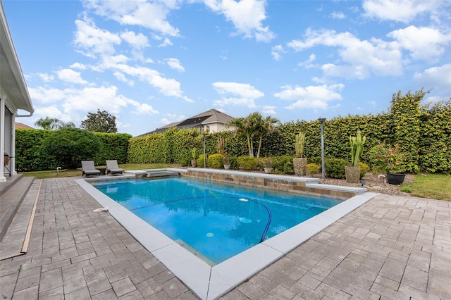 view of swimming pool featuring a patio area, a fenced in pool, and a fenced backyard