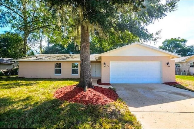 ranch-style house featuring stucco siding, driveway, an attached garage, and a front lawn