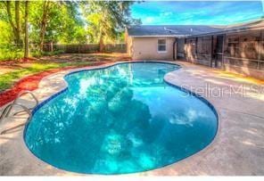 outdoor pool featuring a patio and fence