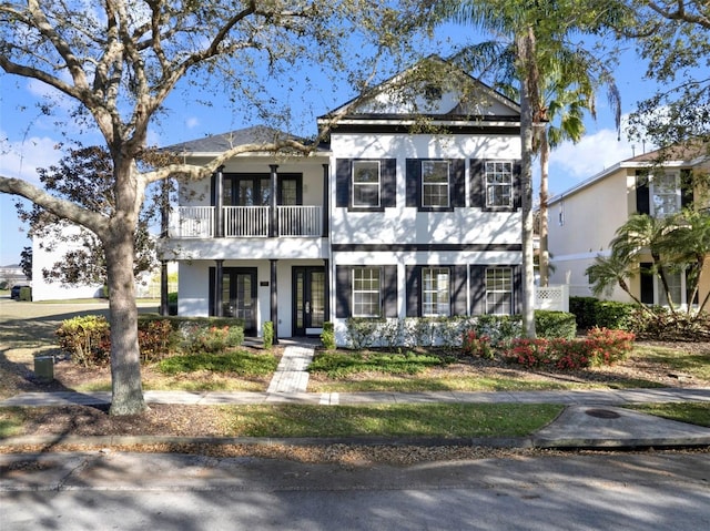 view of front of house with french doors and a balcony