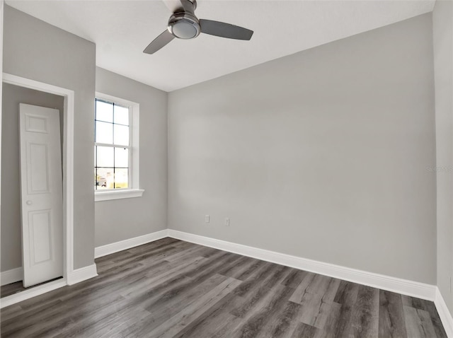 7548 Gathering Dr, Reunion, FL 34747 - spare room featuring dark wood-style floors, a ceiling fan, and baseboards
