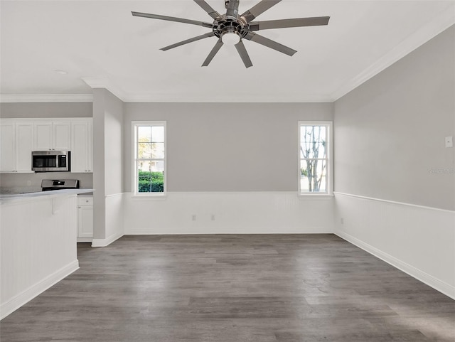 7548 Gathering Dr, Reunion, FL 34747 - interior space featuring a healthy amount of sunlight, dark wood-style flooring, and wainscoting