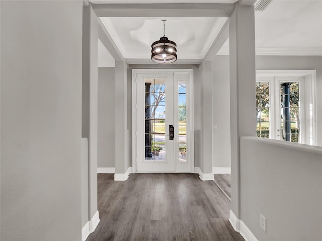 7548 Gathering Dr, Reunion, FL 34747 - entrance foyer with a notable chandelier, baseboards, dark wood-type flooring, and crown molding