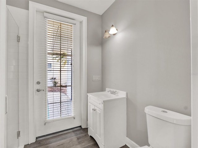 7548 Gathering Dr, Reunion, FL 34747 - bathroom featuring toilet, vanity, plenty of natural light, and wood finished floors