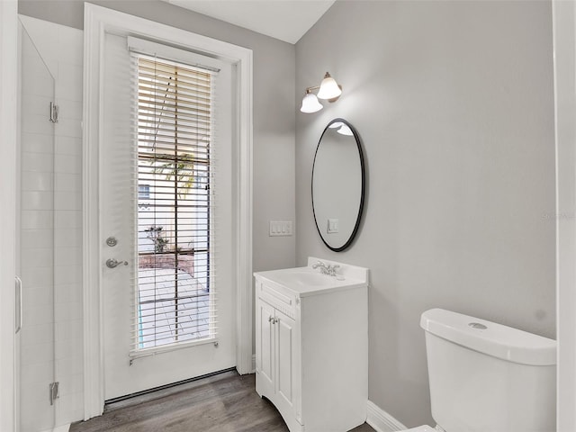 7548 Gathering Dr, Reunion, FL 34747 - bathroom featuring toilet, vanity, a shower, and wood finished floors