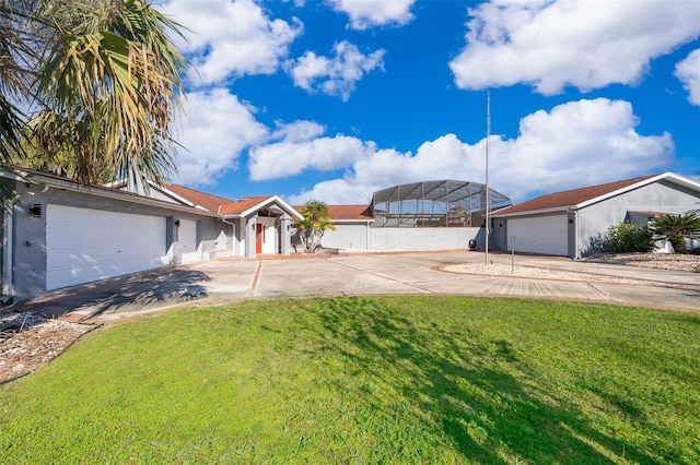 view of front of property with a front yard, driveway, and a garage