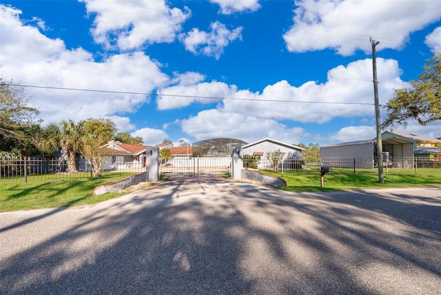 view of front of home featuring a fenced front yard, a front yard, and a gate