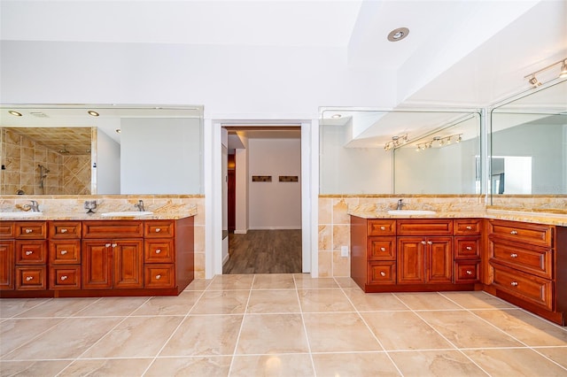 full bathroom featuring tile patterned floors, tile walls, and vanity