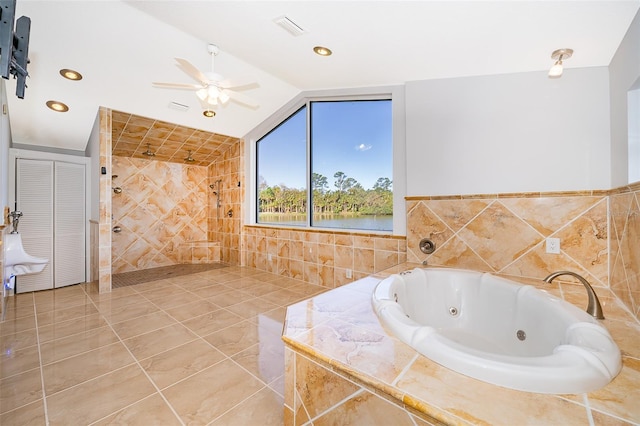 full bath with visible vents, a jetted tub, tiled shower, ceiling fan, and vaulted ceiling