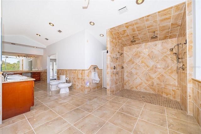 full bathroom featuring visible vents, tile walls, walk in shower, vanity, and vaulted ceiling