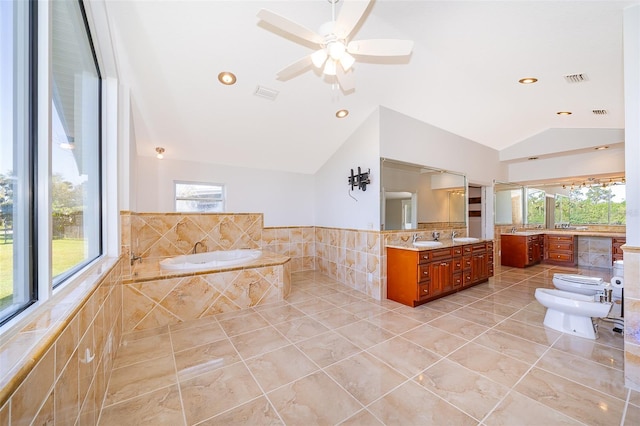 bathroom featuring vanity, a bidet, visible vents, vaulted ceiling, and a bath