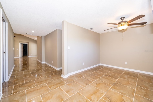 spare room featuring visible vents, a textured ceiling, and baseboards